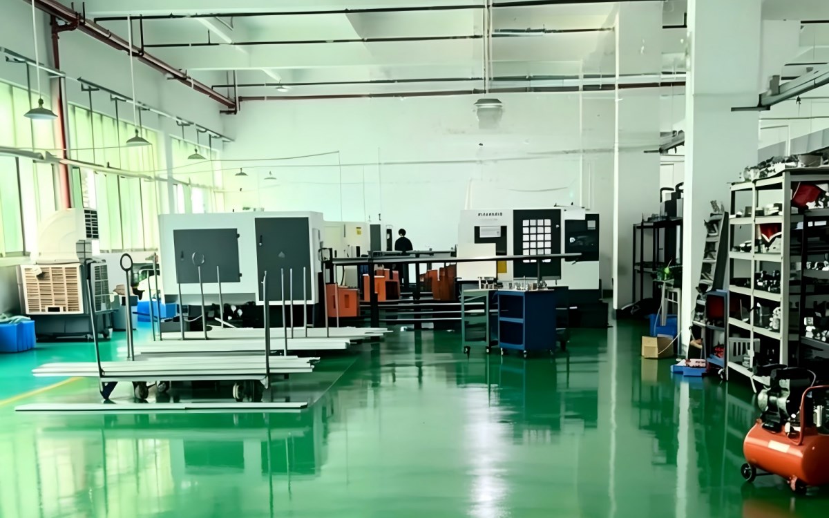 CNC machine tools, material carts and storage racks inside a machining workshop