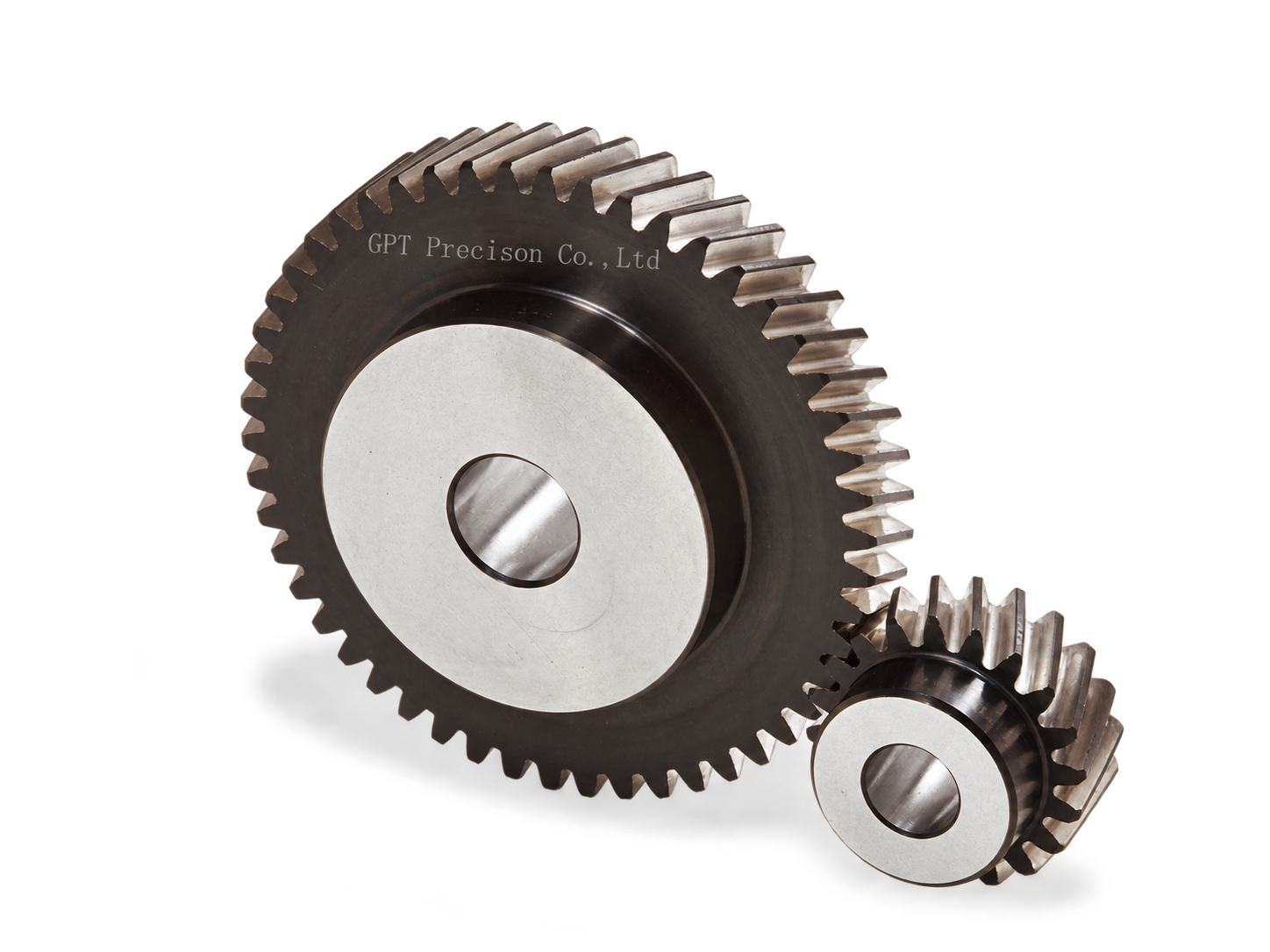 A large metal gear beside a smaller gear with machined teeth and central bores